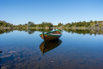 Boat on tranquil lake water in Bleik Andoya, Norway