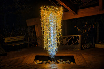 Chandelier illuminating a gazebo at night