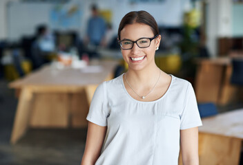 Portrait, smile and creative business woman in office for career, job and startup company. Face, glasses or happy professional entrepreneur, designer or young employee working at workplace in Germany