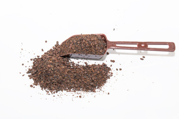 Black Tea powder in the spoon isolated on white background
