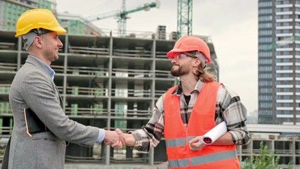 Team of building experts greeting one another before site inspection