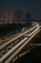 Long exposure of car light trails entering Jakarta from the Bekasi Highway Railway