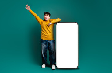 man with animated pose celebrating happily, leaning on a giant cell