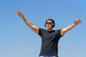 Man with attitude, listening to music on headphones and dancing. Headshot.