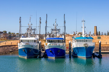 3 Fishing boats moored.