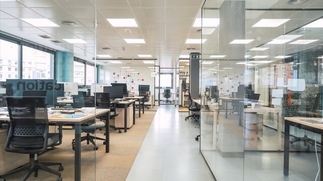 Interior of spacious creative coworking workspace with computer desks