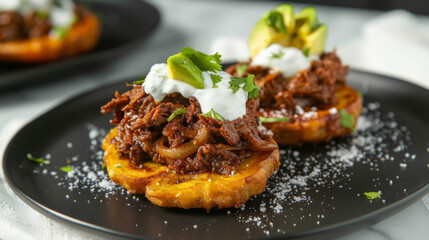 Traditional venezuelan cuisine: grilled arepas topped with savory shredded beef, fresh cream, cheese, and avocado
