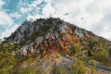 the view from below of a tall mountain on top of a hill