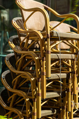 secured chairs stacked on top of each other from a street cafe