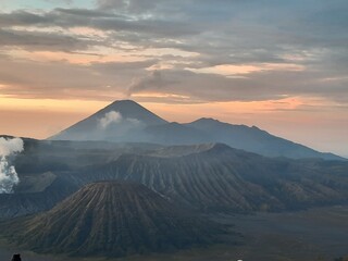 Fototapeta premium The Bromo Tengger Semeru National Park Landscape View. Panoramic View of Mount Bromo and Active Semeru Volcano at Sunrise.