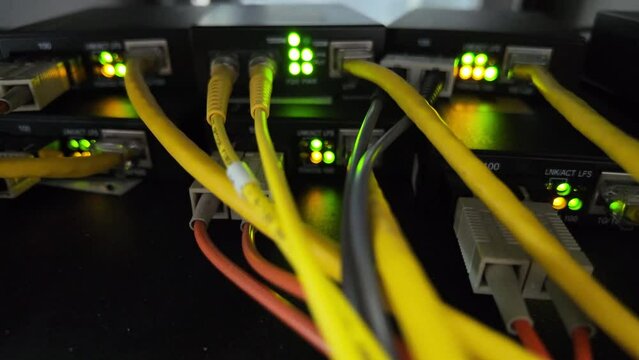 Fiber optic cables for connecting multi-mode and single-mode networks and communications systems with media converters and background lighting.