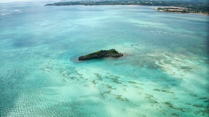 an island in the middle of a lagoon surrounded by green water