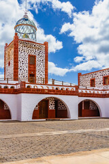 The beautiful lighthouse building of Punta La Entallada (Faro de La Entallada or Punta Lantailla). ...