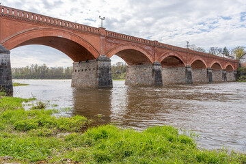 Fototapeta premium The old red brick bridge across the Venta river. Kuldiga, Latvia