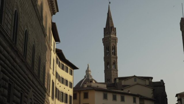 Catholic monastery of Badia Fiorentina against blue sky at sunrise in the center of Florence, Italy