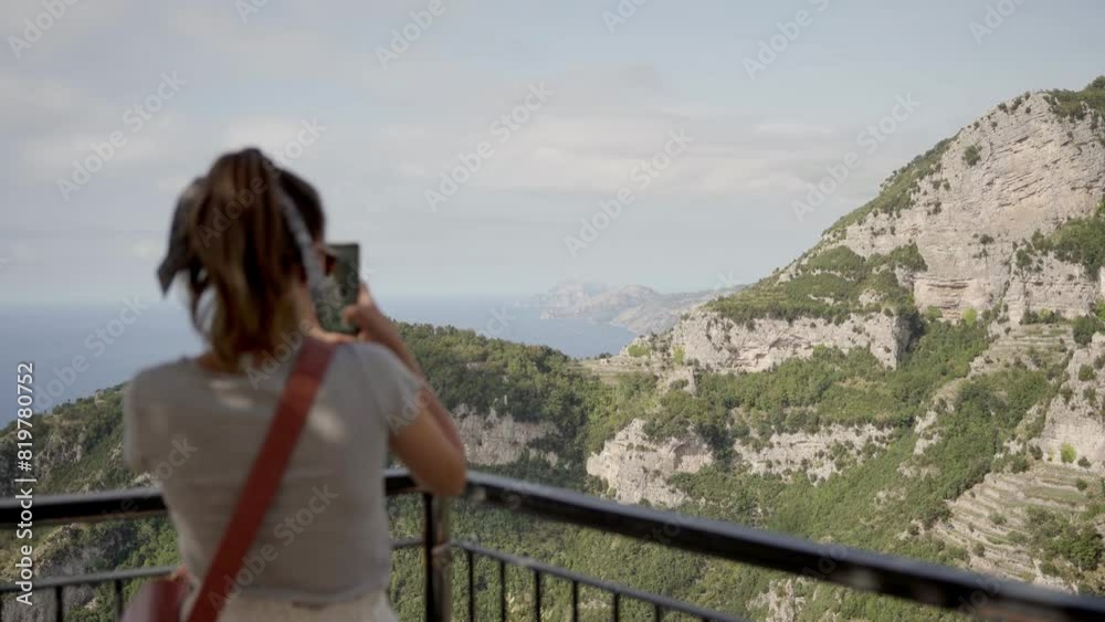 Wall mural caucasian female tourist watching the path of the gods trail on amalfi coast cliffs seaside in italy - Wall murals
