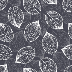 Seamless background with translucent silhouettes of tree leaves chaotically arranged on a gray background. For fabric, cover, wrapping paper, packaging.