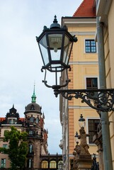 Vertical shot of vintage street lantern against architectural building
