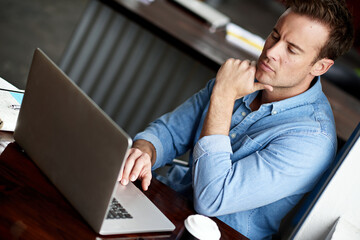 Businessman, laptop and thinking with decision at cafe for choice, research or browsing at indoor...