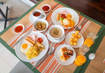 A table with a variety of breakfast food items including eggs, sandwiches, and fruit