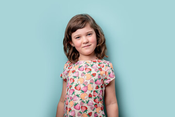 Young girl posing in a colorful fruit pattern dress