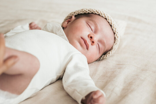 Peaceful newborN sleeping soundly in a knit cap