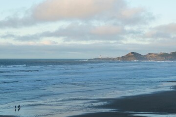 Cloudy sky over the blue sea captured from the coast
