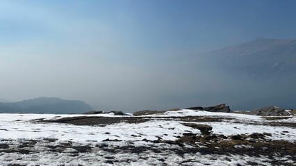 Picturesque snow-covered landscape with the sun shining in the background