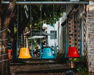 three different color swings in the park