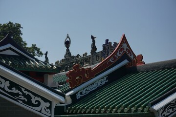 Scenic cityscape of China temple featuring a green rooftop adorned with red and white decorations