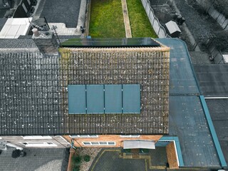 Aerial view of solar panels on the rooftop of a residential house.