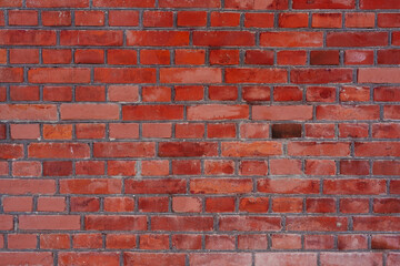 Close-up of a textured red brick wall