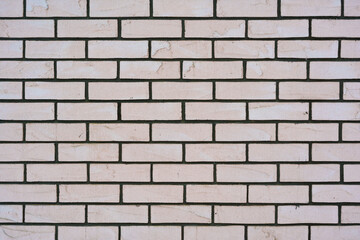 Close-up of a textured beige brick wall