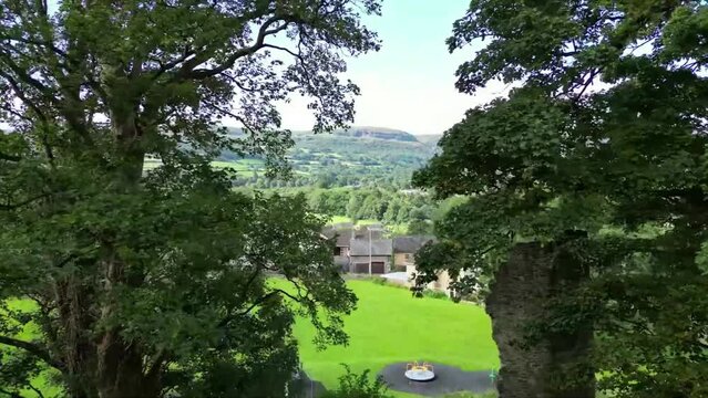 Drone footage of houses and green rolling hills in the background in Crickhowell town, Wales, UK