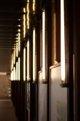 columns. A wall with a lot of lights. Slim, vertical lamps mounted on an outdoor wall.