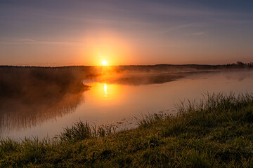 Sunrise over the Suprasl River at the boulevard in Suprasl.