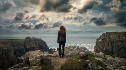 Obraz premium A woman standing on top of a rocky cliff. Perfect for outdoor adventure concepts