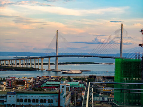 Cebu City, Philippines - The iconic CCLEX or Cebu Cordova Bridge and downtown Cebu as seen from a hotel balcony during sunset.