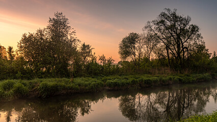 Sunrise over the Suprasl River at the boulevard in Suprasl.