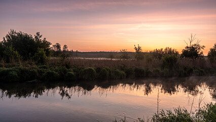 Sunrise over the Suprasl River at the boulevard in Suprasl.