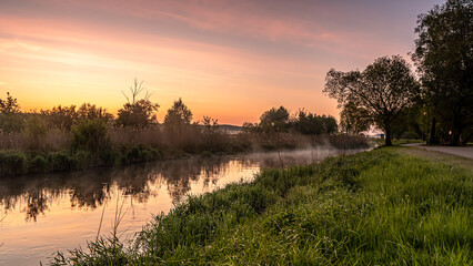 Sunrise over the Suprasl River at the boulevard in Suprasl.