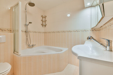 Modern bathroom interior with pale tiles in Sandwijk, Amsterdam