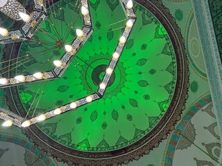 green light reflected from the inside to the mosque dome