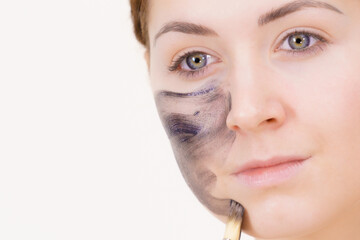 Woman being apply black carbo mask to face