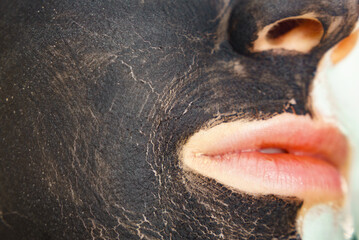 Woman with charcoal facial mask