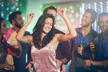 Couple, dance and celebration in club at night on date with freedom and love in relationship. Happy, people and embrace woman in neon lights of disco, party or rave to techno music at festival