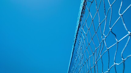 Blue sky background with volleyball net. Net is in focus. Blue sky is blurred.