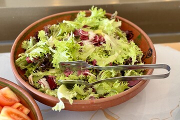 Lettuce salad mix in a beautiful bowl for buffet meals in a restaurant. Vegetables on a plate. Close-up