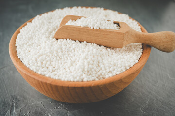 White Sago Pearls in Wooden Bowl Also Know as Sabudana, Tapioca Pearl or Sago Seeds isolated on Gray Background