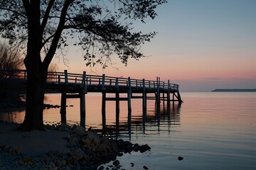 Obraz premium Pink_and_blue_sky_and_sea_and_with_shore_wooden_bridge.jpg